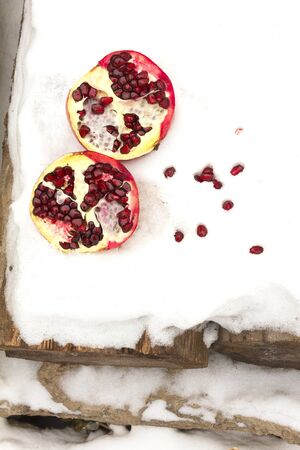 pomegranate fruit in the background White snow for inscriptionsの写真素材
