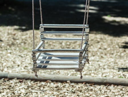 Empty swing on children playground in city.の写真素材