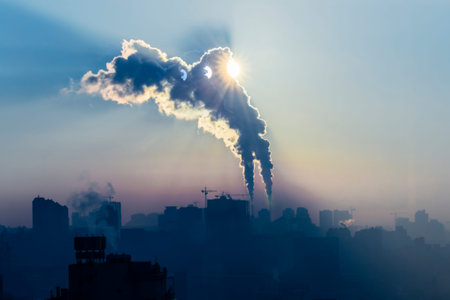 Power plant with smoking chimneys. City