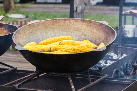 Grill with popcorn in a black cast iron pan. nature, autumnの写真素材