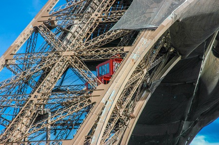 Paris. Unusual Eiffel Tower lifts that take passengers to the viewing platforms. They are located on the legs of the tower and follow the curvature of the structure.の写真素材