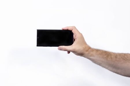 Man holding smartphone on white background, closeup of hand. isolatedの写真素材