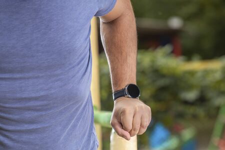Well built muscular man doing a physical exercise outdoors. watchの写真素材