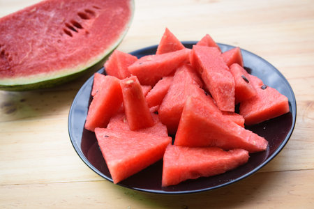 sliced watermelon on plate with wood table backgroundの写真素材