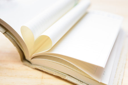 Shape of Heart book on wood table background