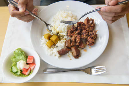 Thai food in dish and man eatの写真素材