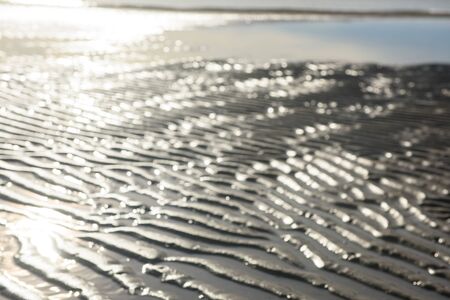 closeup of sand pattern of a beach in the summerの写真素材