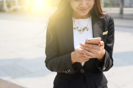 working woman writing note outdoorの写真素材