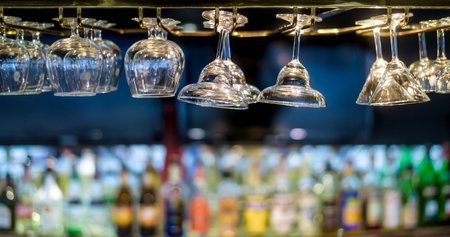 Glasses hanging over a bar rack in the hotel restaurant.の写真素材