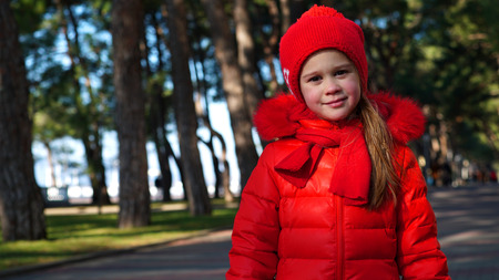 Cute girl in autumn park portraitの写真素材