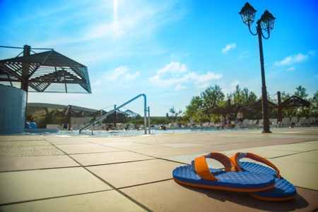 Colored slippers near swimming pool at poolsideの写真素材