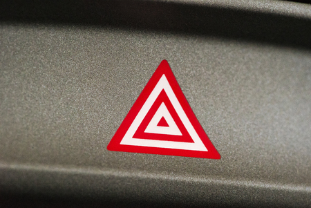 Emergency attention light button in red triangleの写真素材