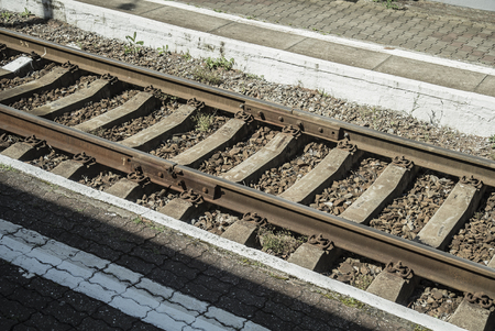 Rails and sleepers on retro railway stationの写真素材