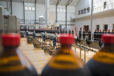 Close up of plastic beer bottle industry on a conveyor beltの写真素材