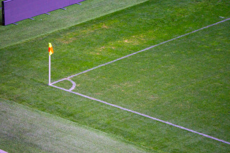 Yellow flag in corner of football playground, lazy wind blowing