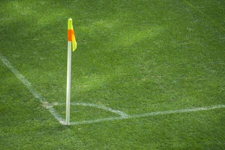 Yellow flag in corner of football playground, lazy wind blowingの写真素材