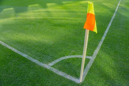 Yellow flag in corner of football playground, lazy wind blowing.の写真素材