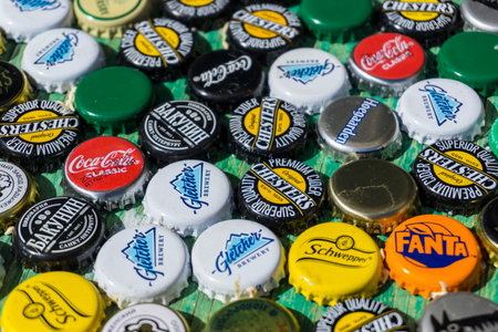 Krasnodar, Russia - April 29, 2018: Beer bottle caps, a mix of global brands: Chesters , Gletcher, Coca-Cola etc.のeditorial素材
