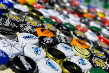 Krasnodar, Russia - April 29, 2018: Beer bottle caps, a mix of global brands: Chesters , Gletcher, Coca-Cola etc.のeditorial素材