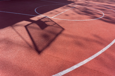 Shadow on the court of basketball basket with chains on streetball courtの写真素材