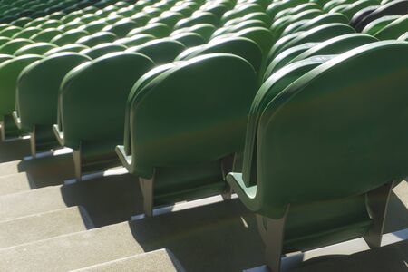 Empty plastic seats in a stadium. Matches to be played without fansの写真素材