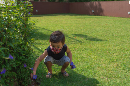 Child boy using a mask playing and sliding in a playground