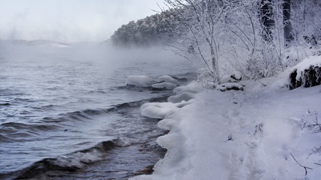 Winter scene in Russia by the lake - water, mist, snow forest and mountainsの写真素材