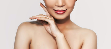 beautiful woman's face From nose to chest Showing bright red lips And clean, healthy natural skin cleared, under the concept of beauty And skin careの写真素材