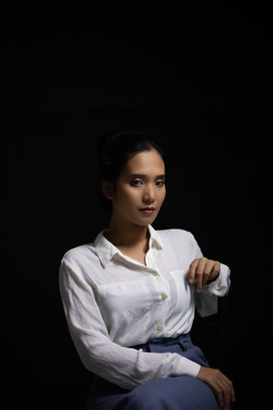 An Asian woman wearing a white long-sleeved shirt with an office style Korean fashion girl Poses...