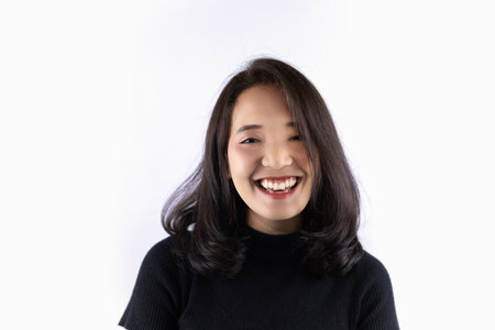 Short haired girl Wearing a black T-shirt Laughing joyfully on the White Blackgroundの写真素材