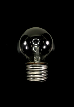 Old bulb lamp isolated black backgroundの写真素材