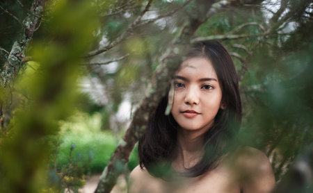 Close-up pictures of beautiful young Asian women, with perfect smooth tan skin. Concept of natural cosmetics and skincare.の写真素材