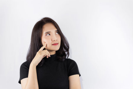 Short haired girl Wearing a black T-shirt Use her index finger to touch her cheek. Show some...