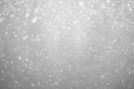 Bokeh background and bubbles reflecting black and white lightの写真素材