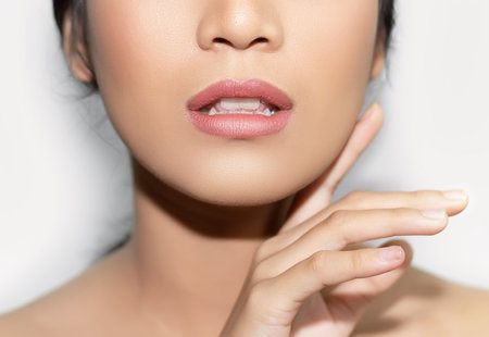 beautiful woman's face From nose to chest Showing bright pink lips And clean, healthy natural skin cleared, under the concept of beauty And skin careの写真素材