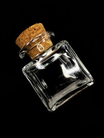 Square bottle with cork isolated black backgroundの写真素材