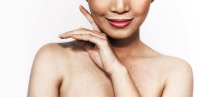 beautiful woman's face From nose to chest Showing bright pink lips And clean, healthy natural skin with blemishes and freckle, under the concept of beauty And skin careの写真素材
