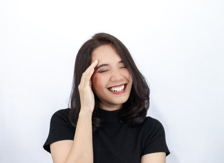 Short haired girl Wearing a black T-shirt Laughing joyfully on the White Blackgroundの写真素材