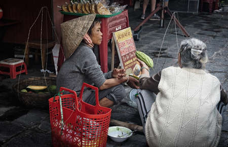 Binh Thuan,VIET NAM-DECEMBER 16,2018: Vietnamese market trader  selling products on the corridor. Vietnamese lifestyle.Dramatic pictureのeditorial素材