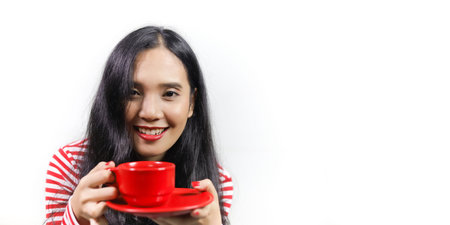 Asian women holding a red cup of coffee. She wears a white-red striped shirt, red lipstick and red...