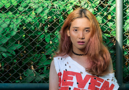 The woman who dyed the hair until the hair was dry But looks beautiful With the sun shining at her hairの写真素材