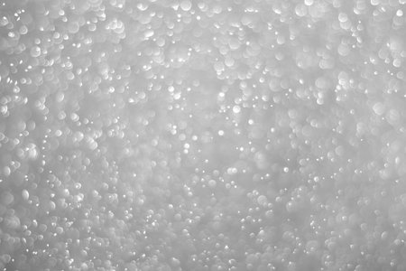 Bokeh background and bubbles reflecting black and white lightの写真素材