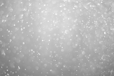 Bokeh background and bubbles reflecting black and white lightの写真素材