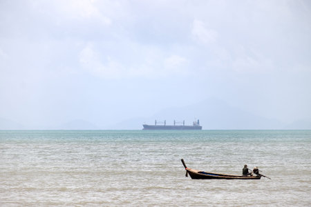 KRABI,THAILAND-AUGUST 18, 2018 : Lifestyle of local fisherman,the fisherman is standing on his small fishing boat and doing something about his occupation in a seaのeditorial素材
