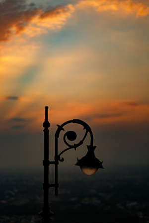 Top of silhouette retro street lamp on twilight sky.の写真素材