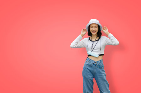 Woman standing on isolated background in casual suit, hat and face mask, Vocation happy trip on...