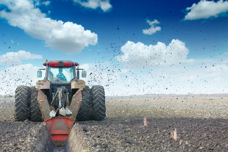 Tractor with double wheeled ditcher digging drainage canalの写真素材