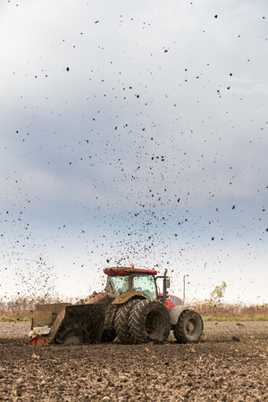 Tractor with double wheeled ditcher digging drainage canalの写真素材