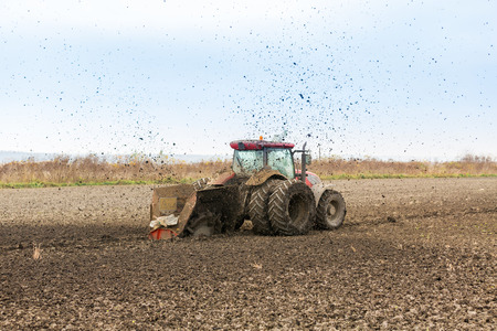 Tractor with double wheeled ditcher digging drainage canalの写真素材