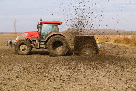 Tractor with double wheeled ditcher digging drainage canalの写真素材